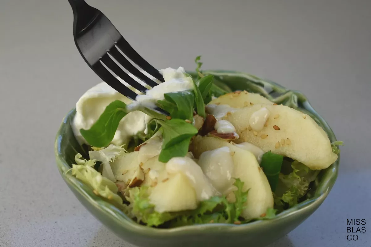 Burrata Pear Salad with almond dressing in a green bowl