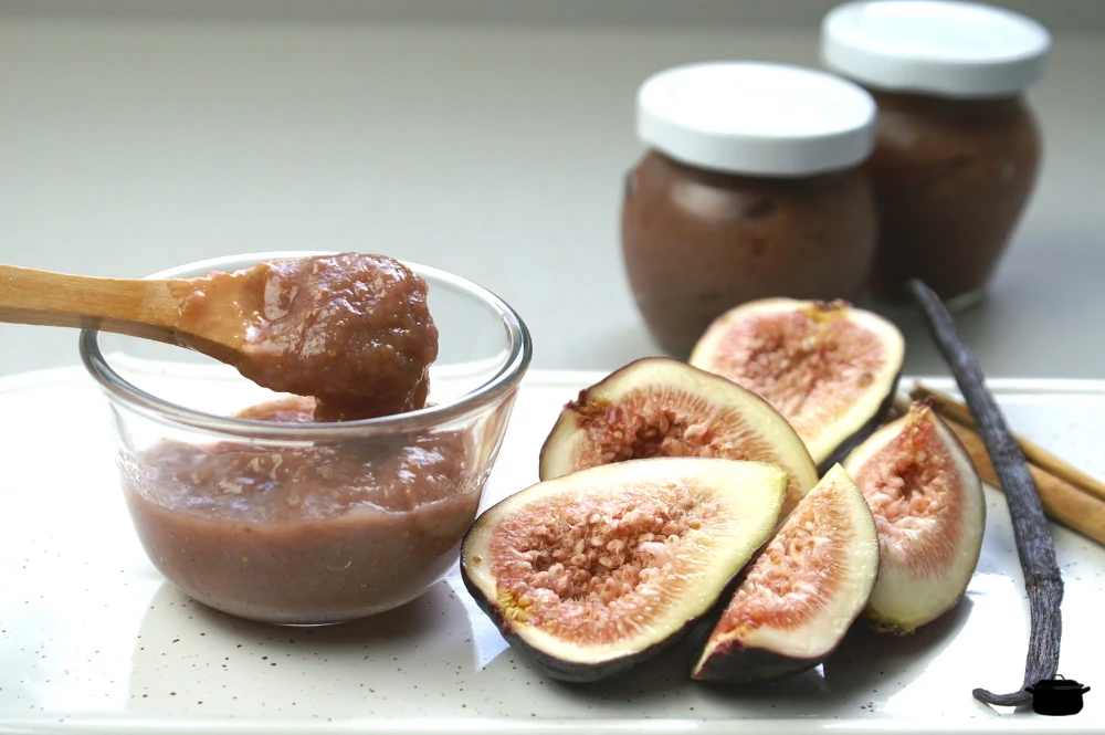Fig sauce ina glass bowl with a wooden spoon