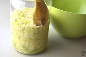 Cabbage in a glass jar with a wooden spoon