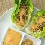 sprouted lentils lettuce wrap with mustard dressing and sesame seeds