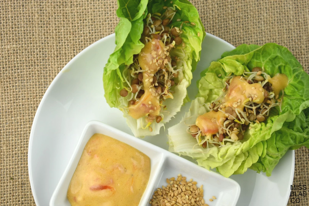 sprouted lentils lettuce wrap with mustard dressing and sesame seeds
